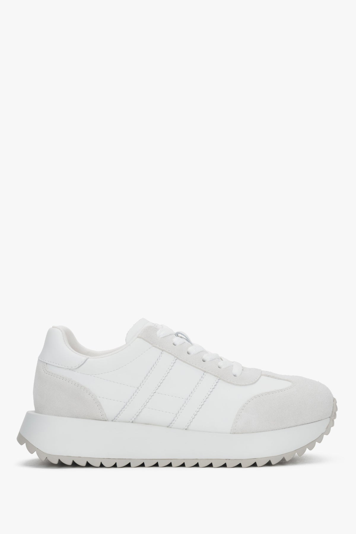 A pair of women's white sneakers crafted from genuine leather and suede.