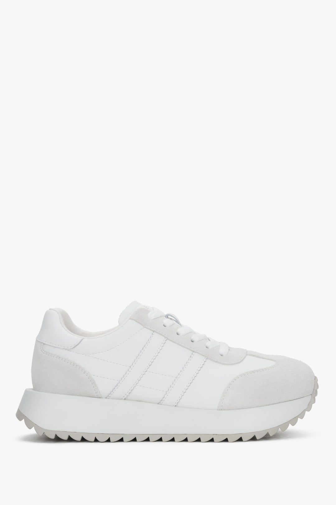 A pair of women's white sneakers crafted from genuine leather and suede.