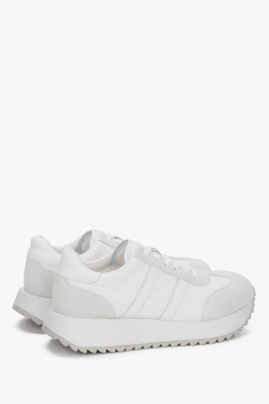 A pair of women's sneakers in white, constructed from a mix of genuine leather and soft suede.