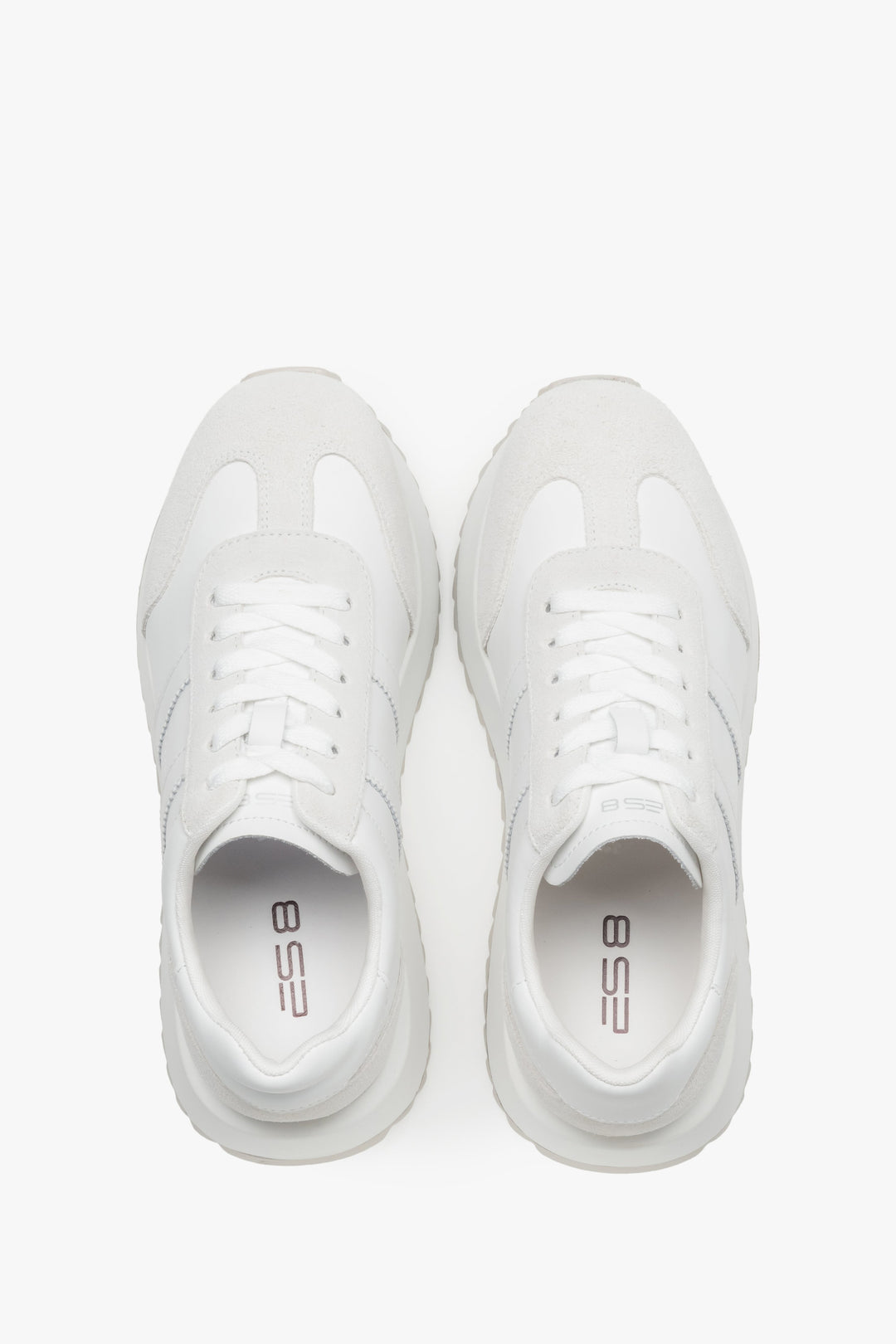 Women's white sneakers combining a smooth leather base with suede panels.