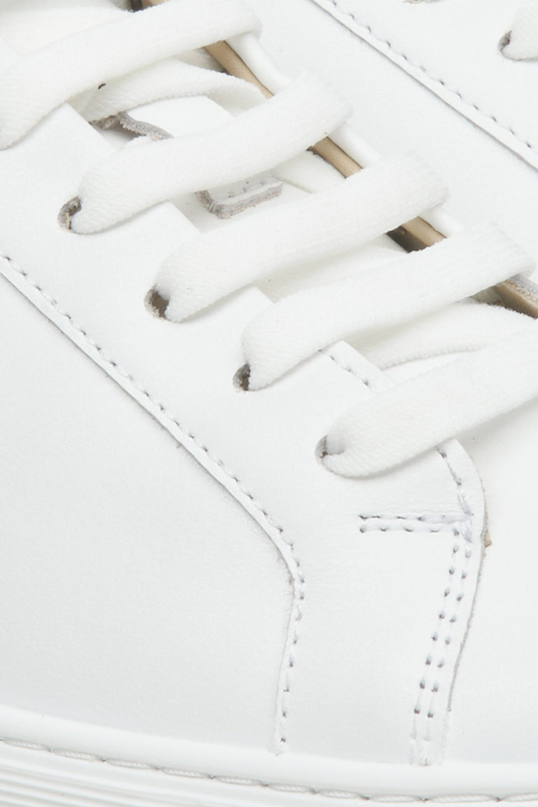 Women's white leather sneakers by Estro with laces for fall - close-up on the details.