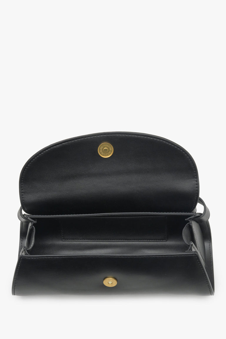 Women's black handbag made of genuine leather - close-up on the interior of the model.