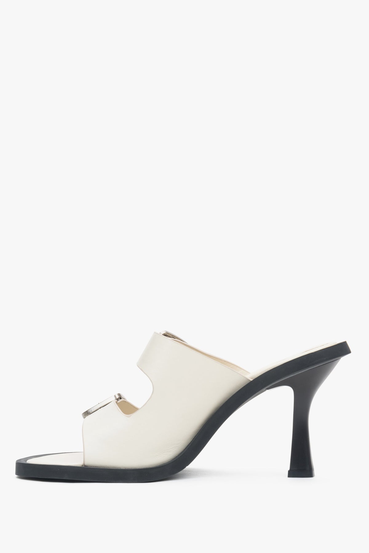 Women's white stiletto mules from Estro with a buckle - shoe profile.