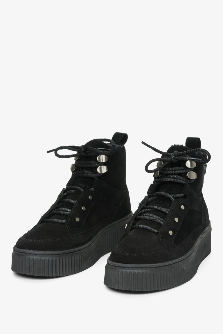 High-top women's winter sneakers in genuine black suede with laces by Estro - close-up on the front of the shoe.