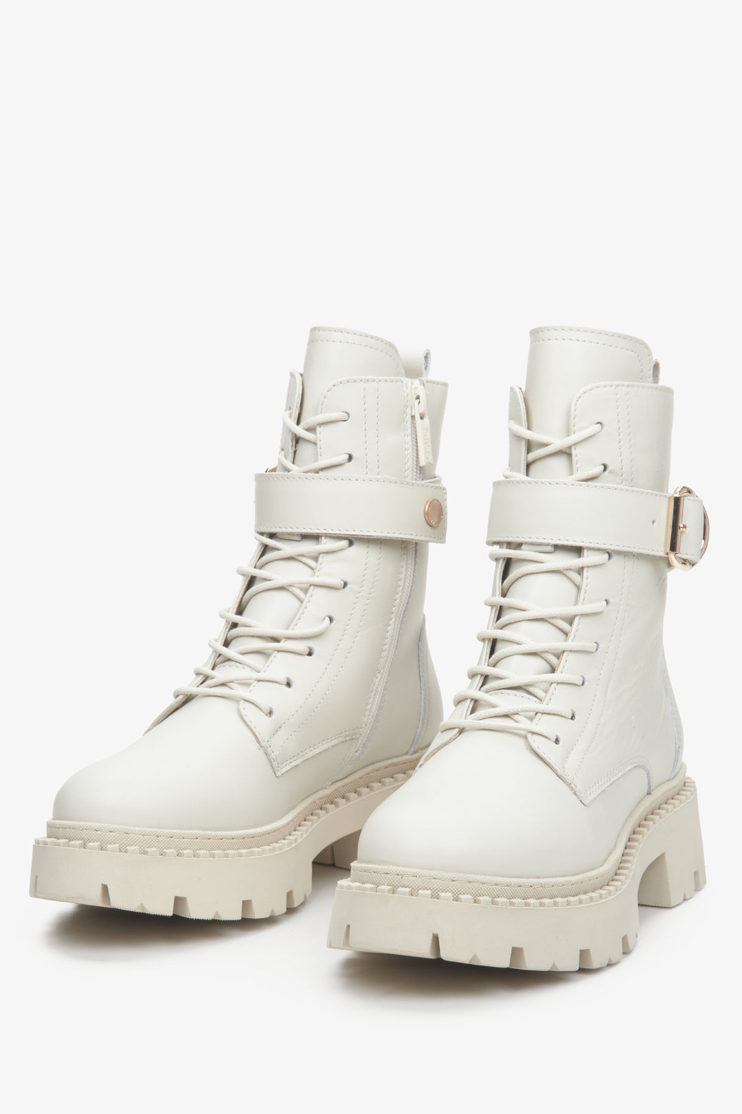 Leather, light beige Estro women's winter boots with a decorative strap - close-up on the toe.