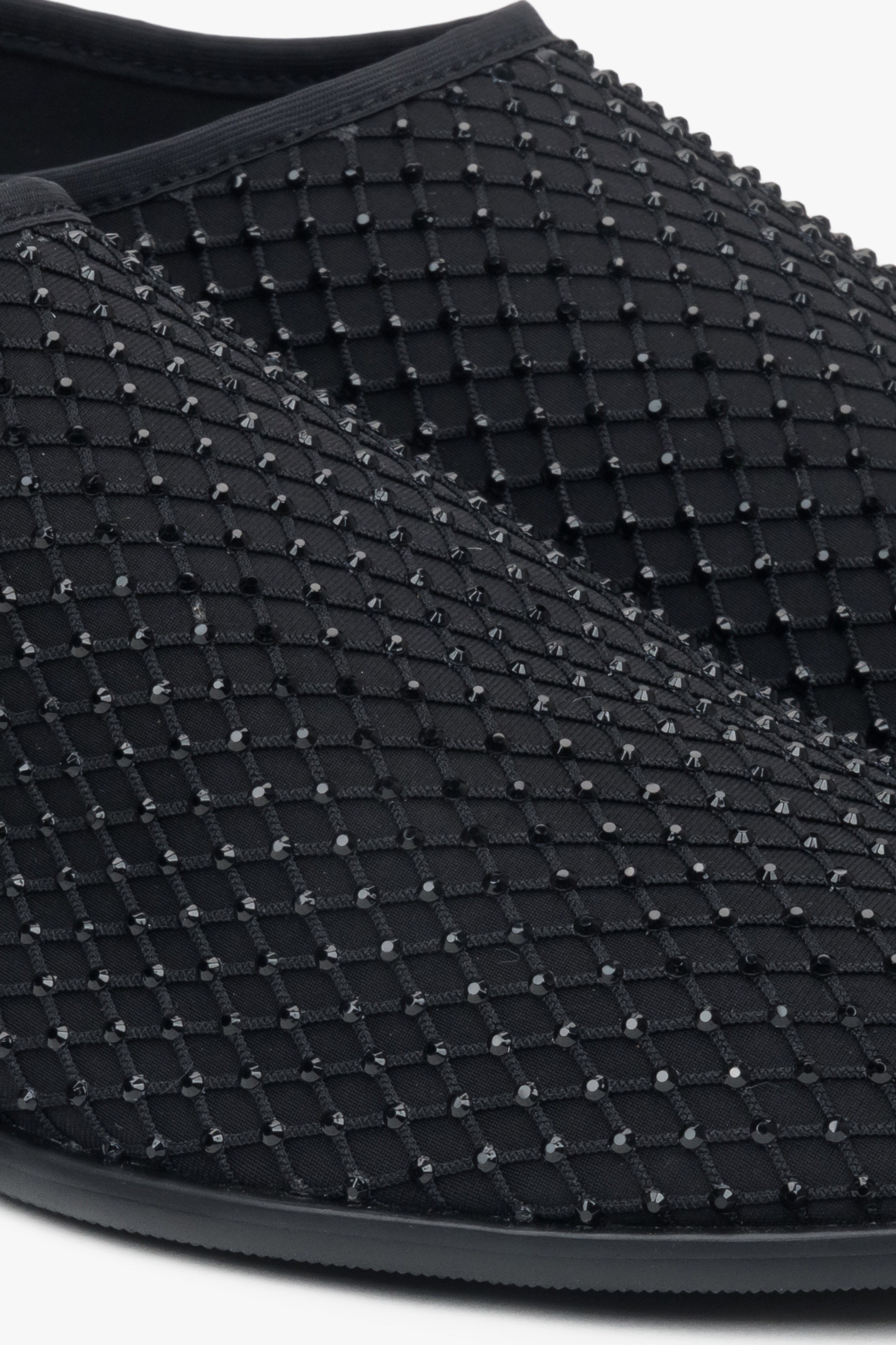 Women's flats by Estro in black, made of soft mesh and adorned with shimmering rhinestones – close-up of the details.