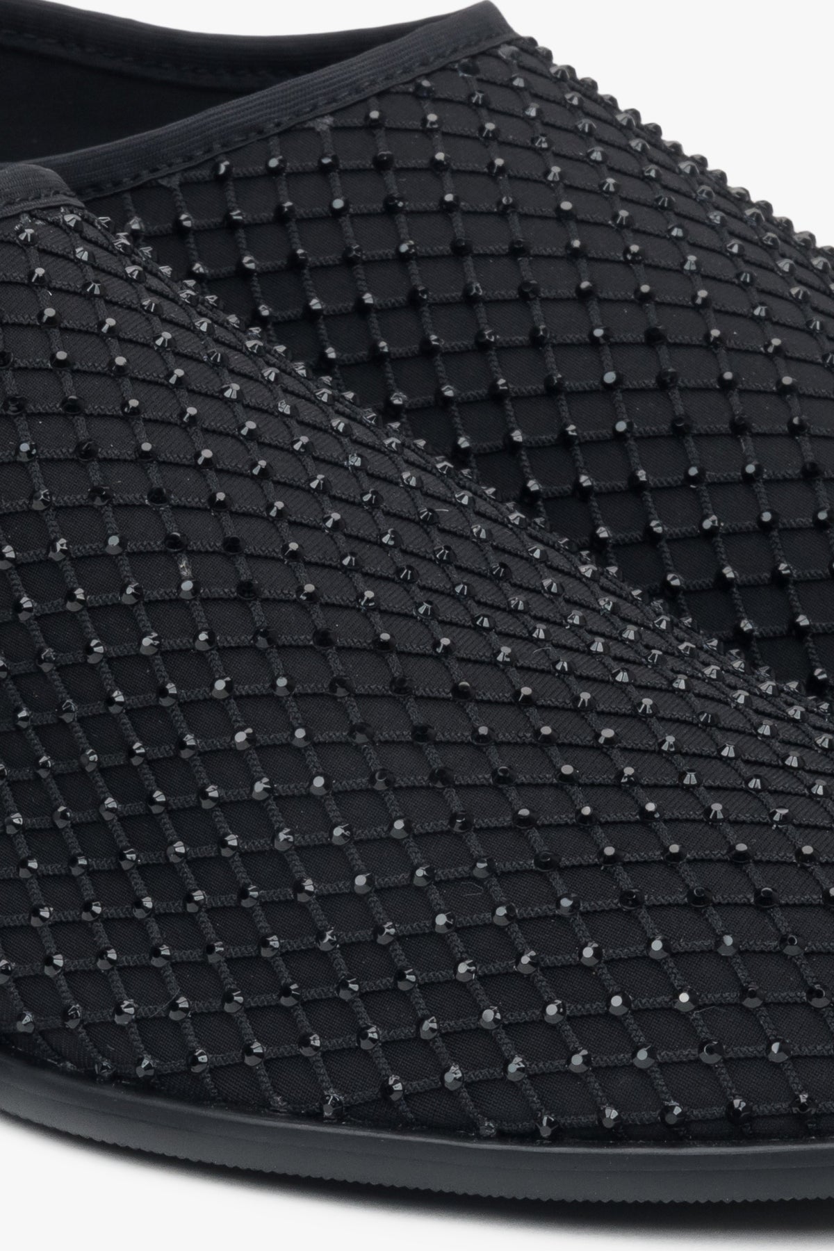 Women's flats by Estro in black, made of soft mesh and adorned with shimmering rhinestones – close-up of the details.