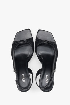Black slingback heeled sandals with decorative lace.