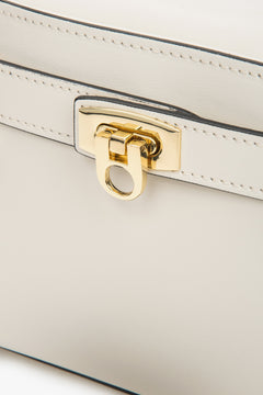 Women's satchel-style handbag made of Italian genuine leather in a light beige shade – close-up on details.