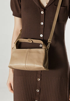 Leather beige handbag by Estro  – presented on a model.
