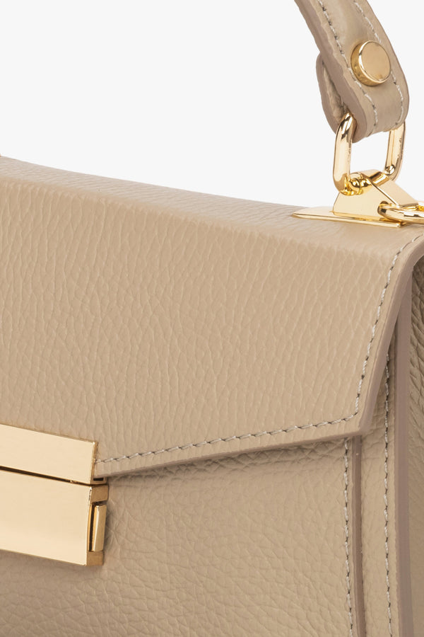 Women's small beige handbag made of premium Italian genuine leather - close-up on details.