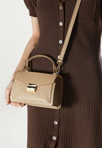 Women's small beige handbag made of premium Italian genuine leather – presented on a model.