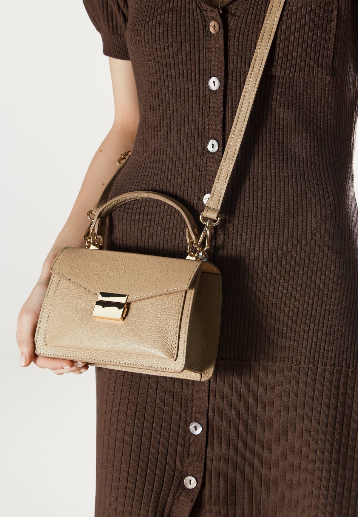 Women's small beige handbag made of premium Italian genuine leather – presented on a model.