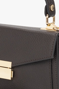 Women's small dark brown handbag made of premium Italian genuine leather - close-up on details.