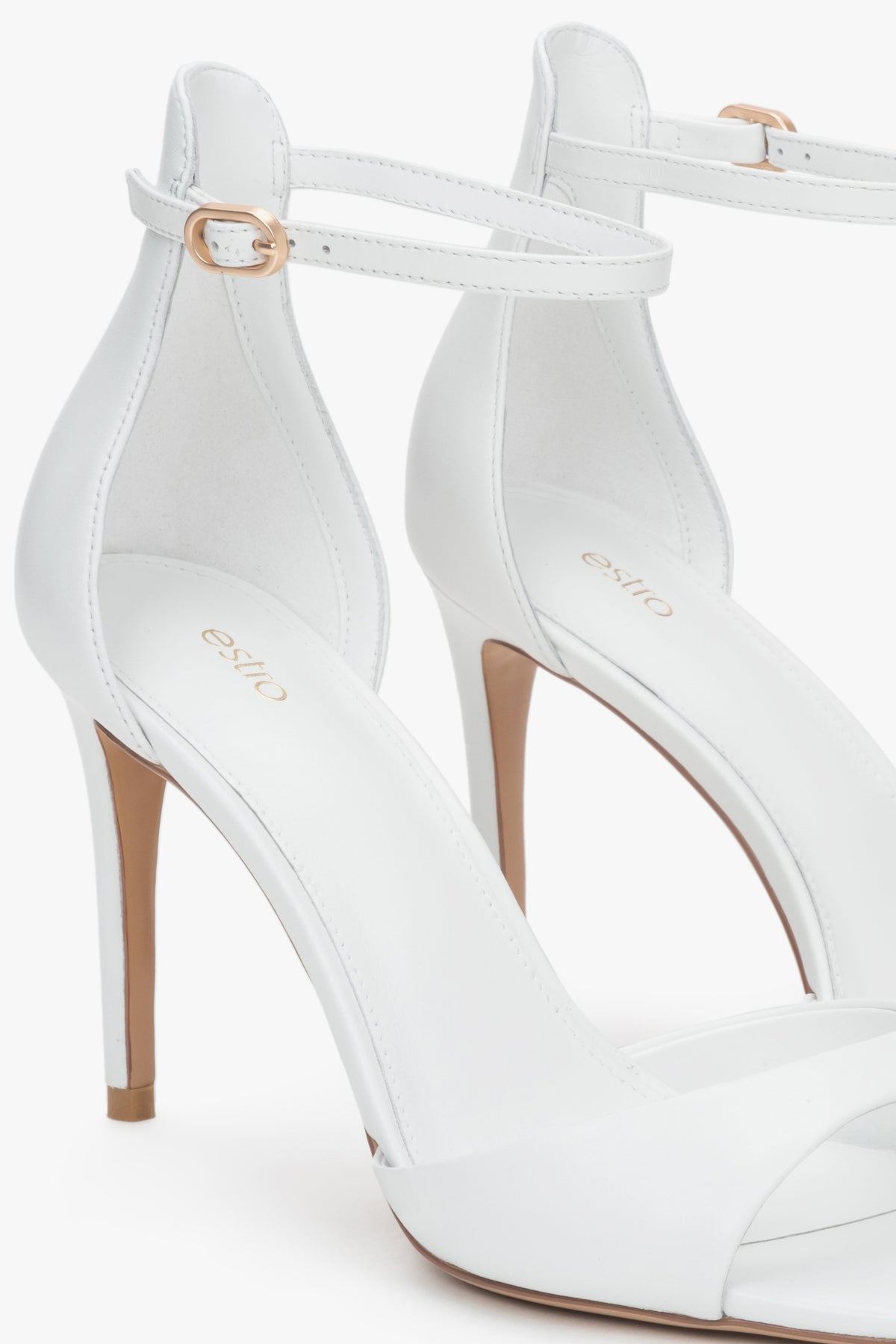 Women's white leather sandals with a high heel by Estro.