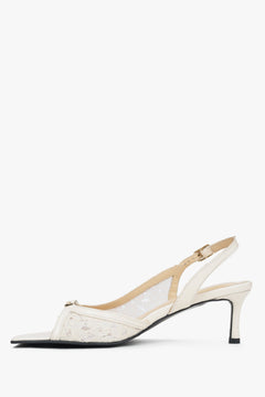 White heeled women's sandals with lace detailing.