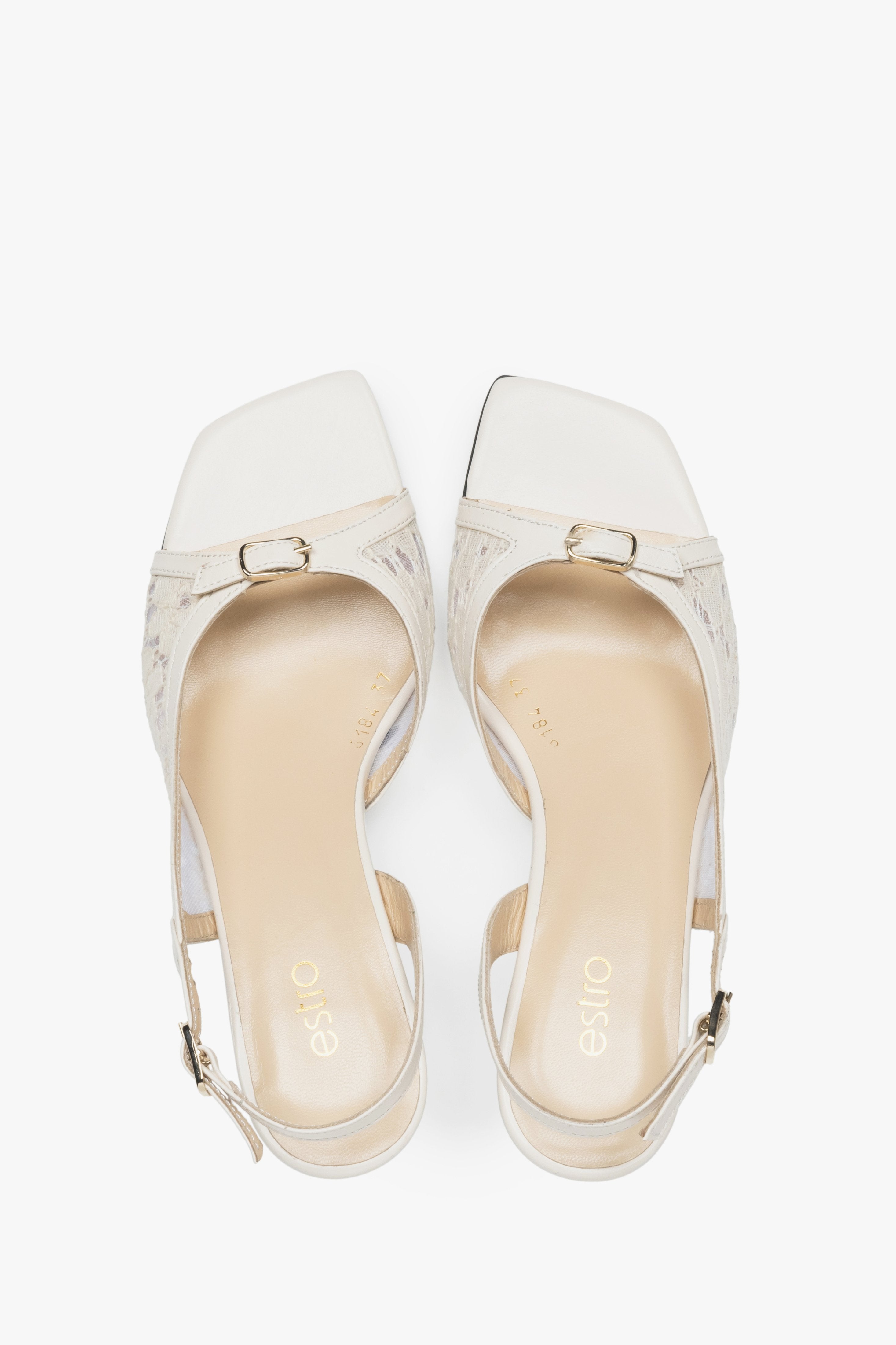 Stylish white slingback sandals with lace detailing.
