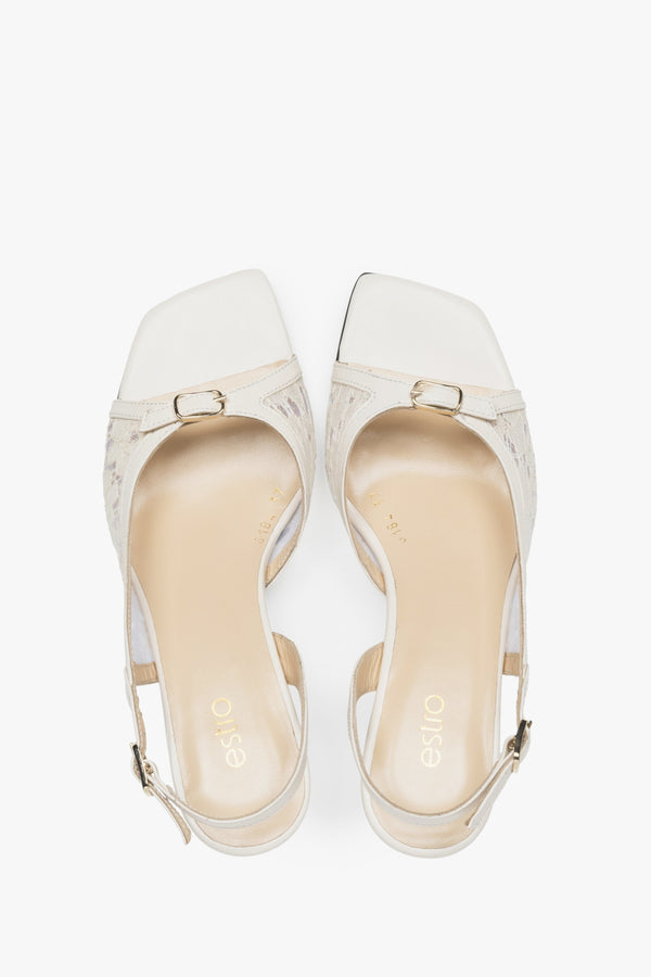 Stylish white slingback sandals with lace detailing.
