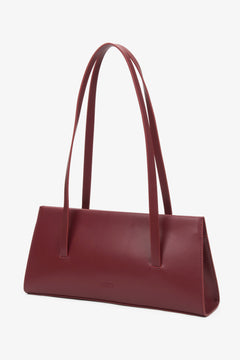 Stylish burgundy women's handbag by Estro, made of natural leather and equipped with long handles for shoulder wear.