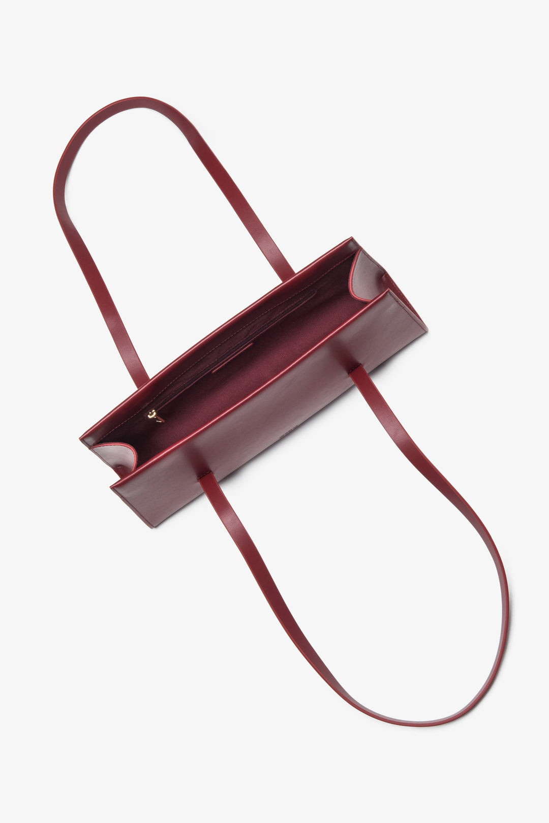 Practical and stylish burgundy women's handbag by Estro, made of natural leather and featuring long handles for easy shoulder wear.