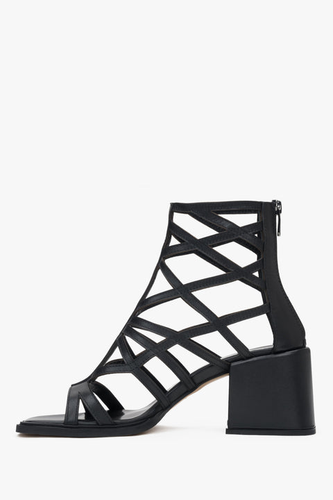 Black perforated gladiator-style heeled sandals by Estro – bold and stylish women's footwear.