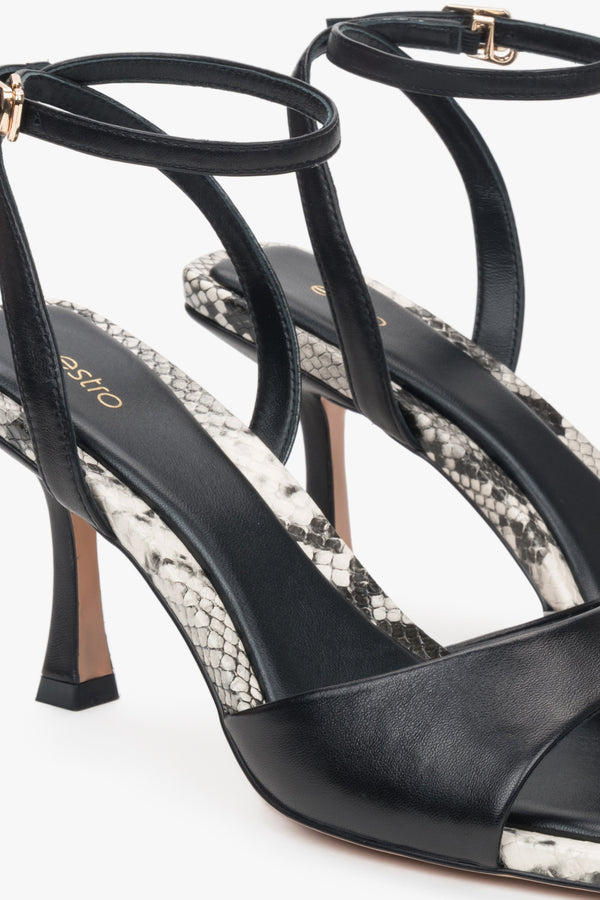 Black leather women's sandals by Estro – animal pattern details.