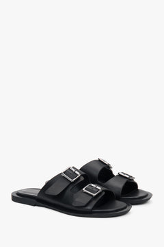 Minimalist black women's leather slides by Estro, featuring two distinctive straps.