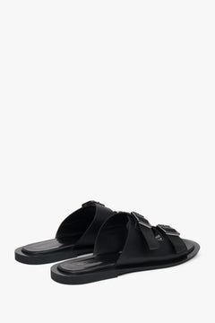 Stylish black women's slides by Estro, made of natural leather and featuring two distinctive straps—perfect for everyday wear.