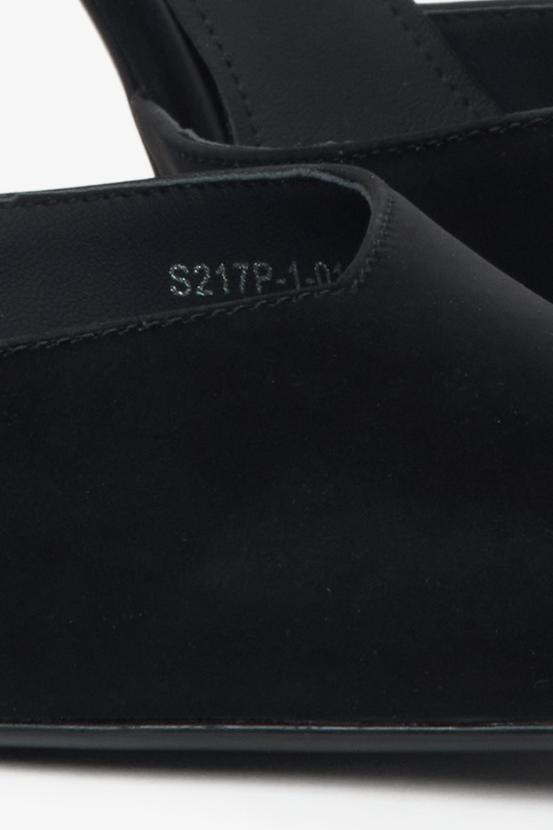 Black pumps on a heel by Estro with crystals and textured finish – close-up of the details.