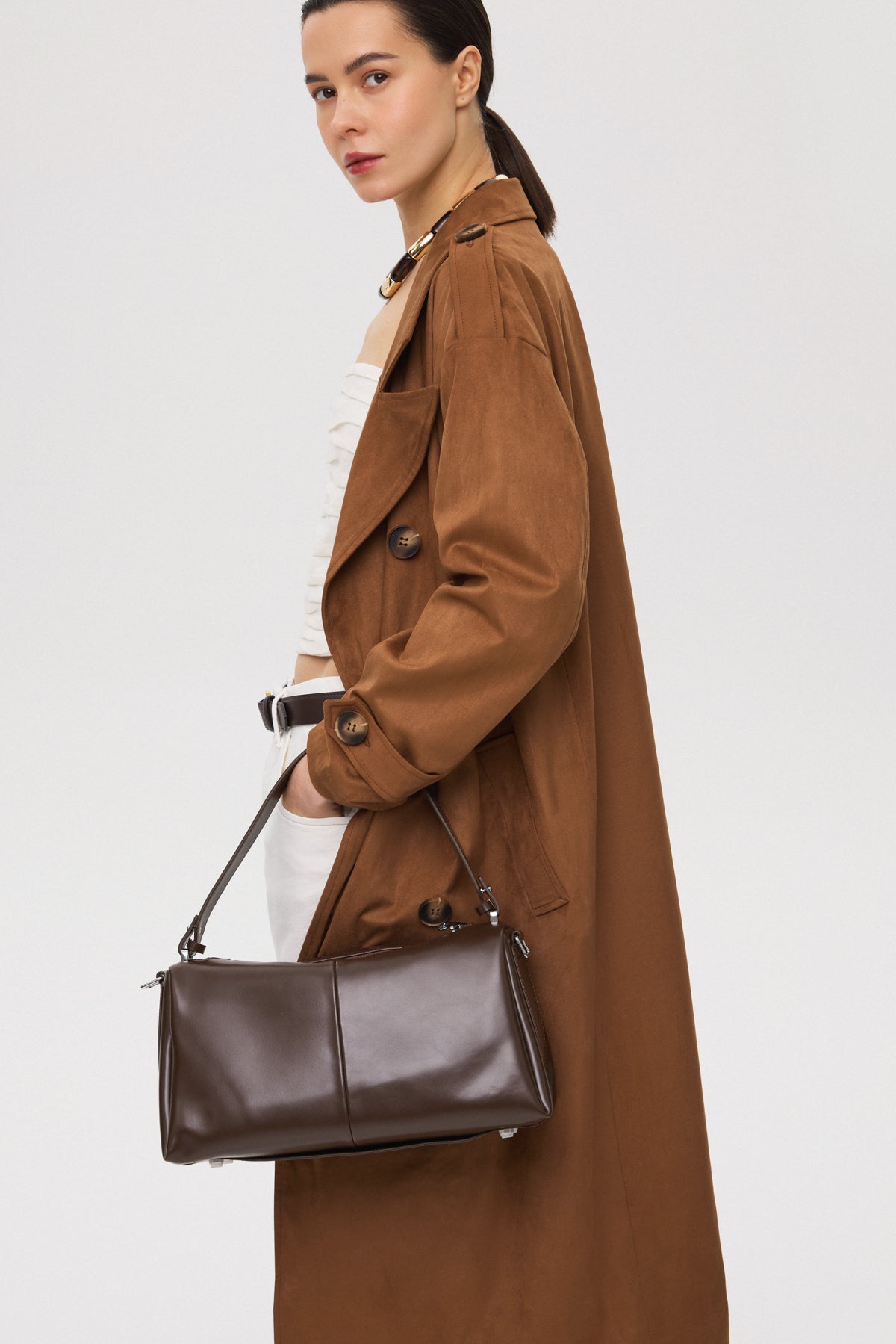 Dark brown women's crossbody bag - model overview in a styled presentation.