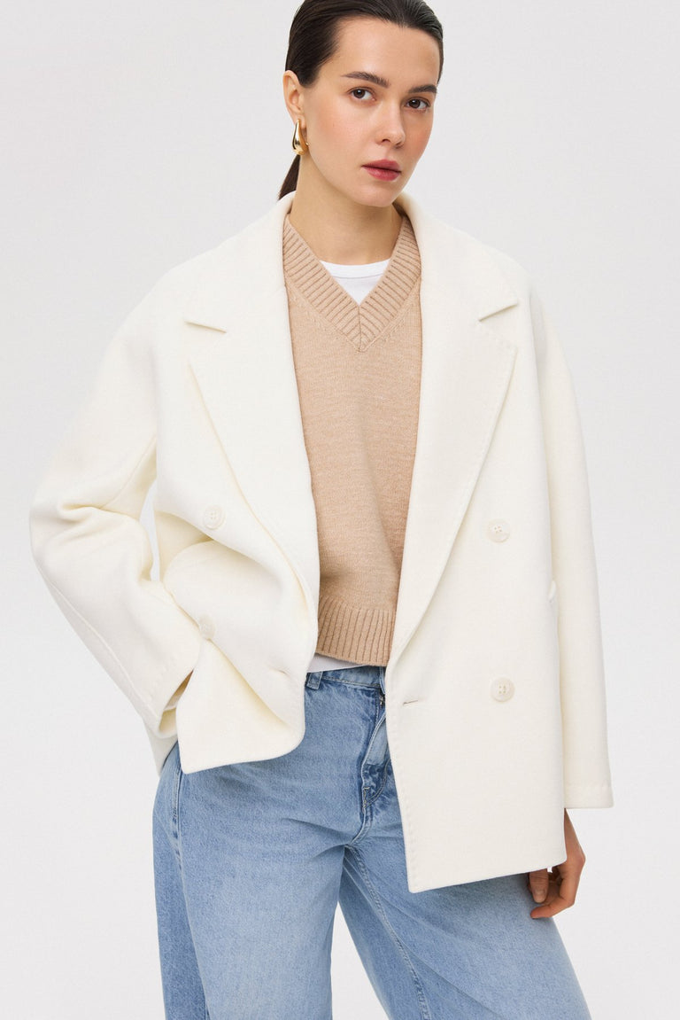 Stylish, short, double-breasted women's coat by Estro in a snowy white shade.