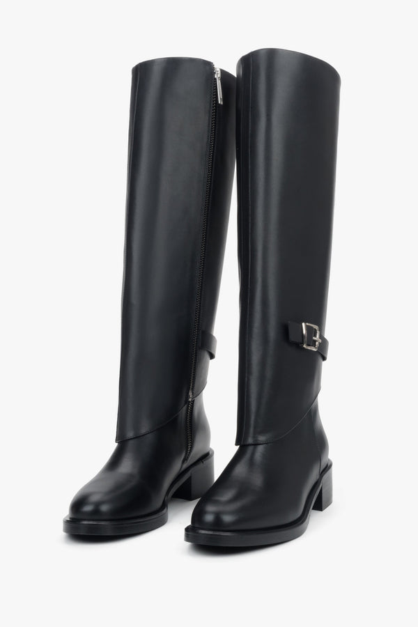 Black 2-in-1 ankle and knee-high boots in genuine leather with decorative buckle.