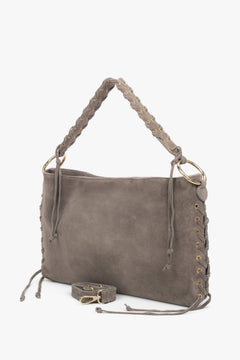 The braided handle and adjustable shoulder strap (up to 125 cm) provide versatile carrying options.