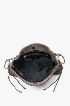 The spacious interior is lined with high-quality textile, offering three compartments and one pocket for organized storage.