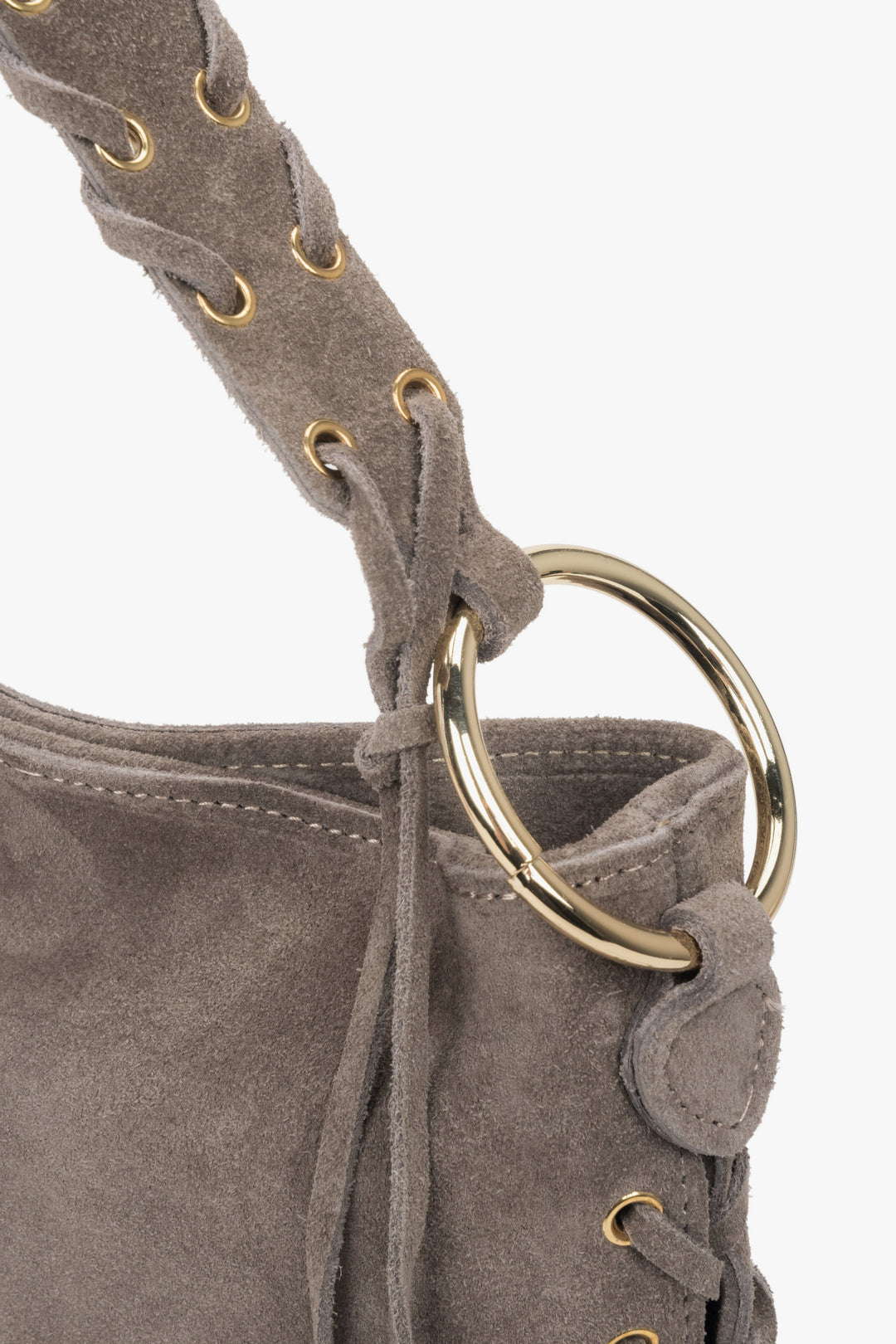 Decorative lacing and metal eyelets on the sides enhance the bag's unique boho charm.