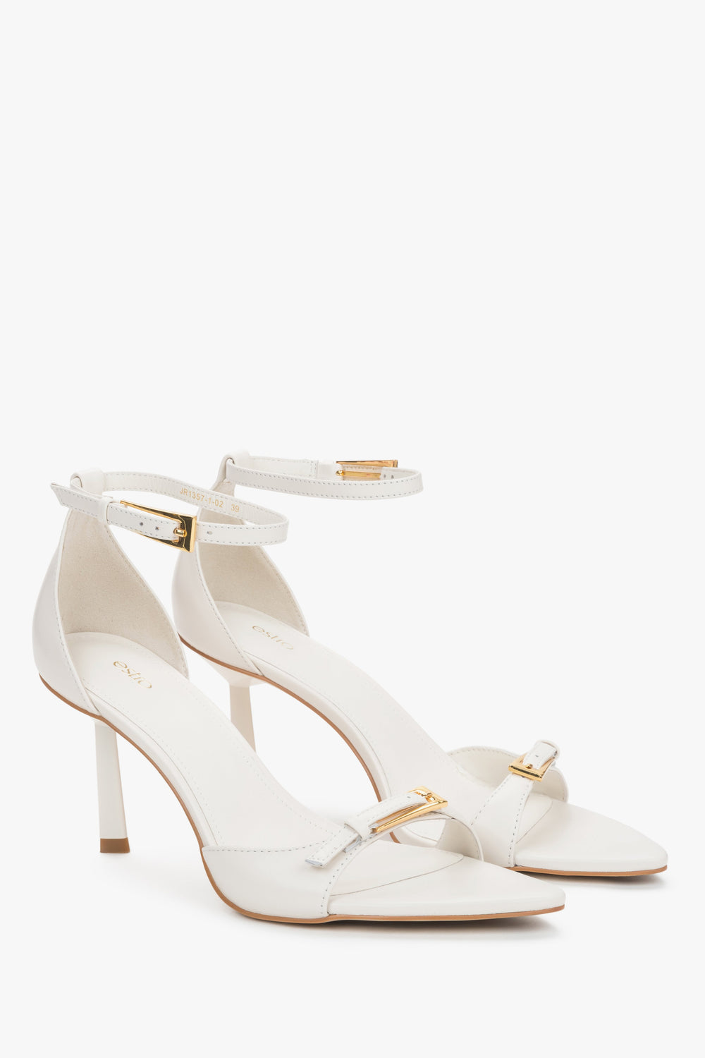 Women's beige leather stiletto sandals by Estro with decorative buckles.