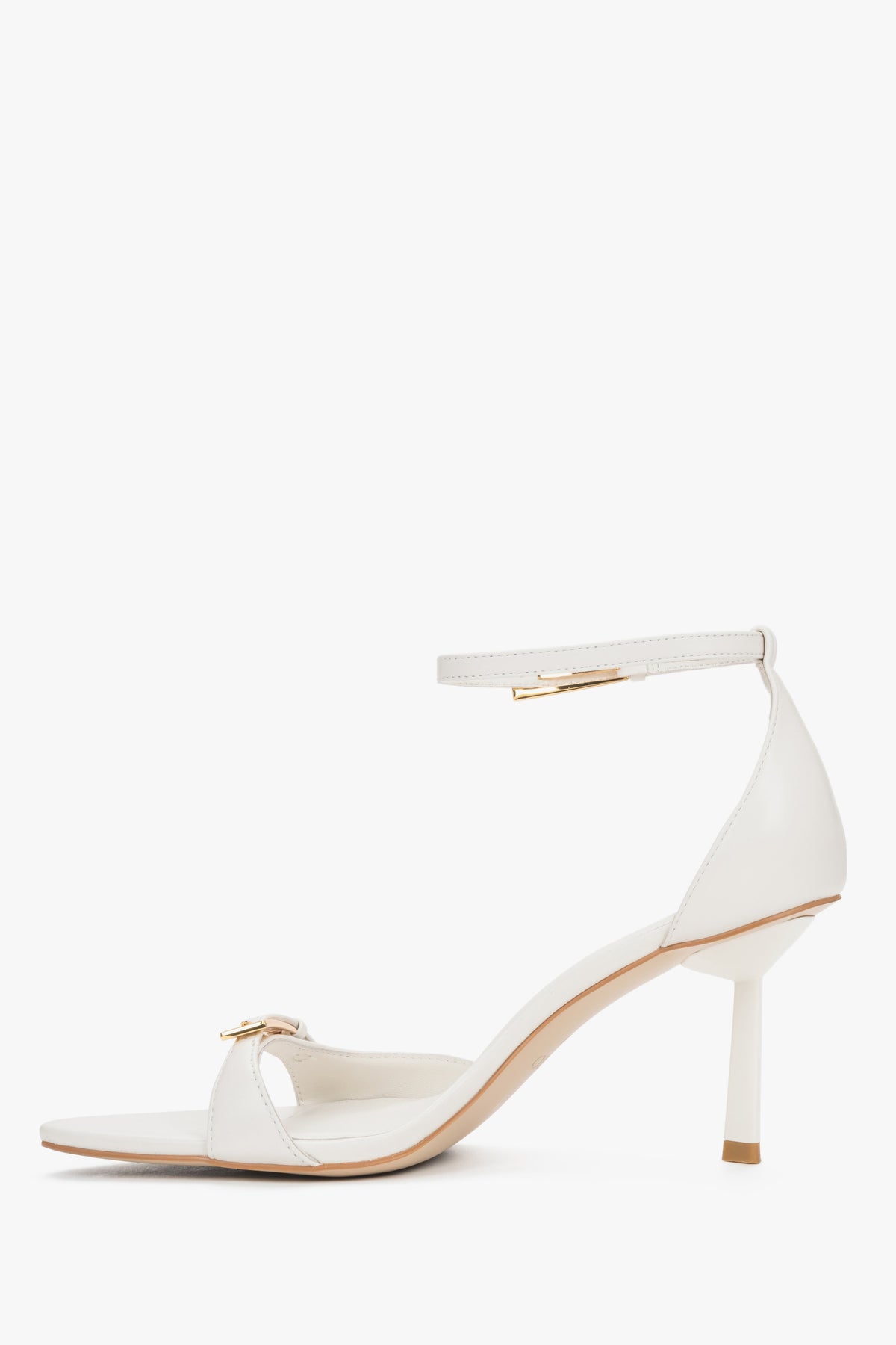 Women's beige leather sandals with decorative buckles and buckle fastening.