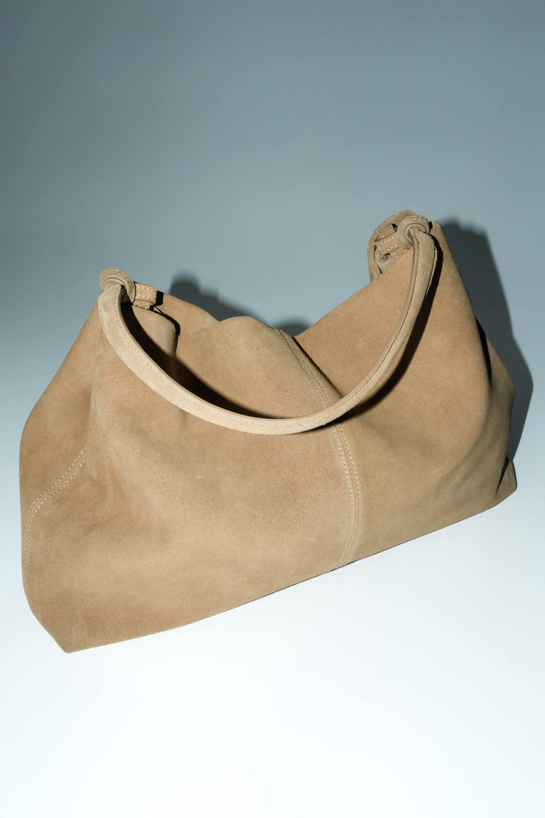 Spacious beige shopper bag with reinforced handles.