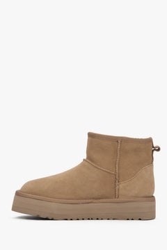 Warm and stylish women's snow boots made of beige velour with a fur-lined interior.