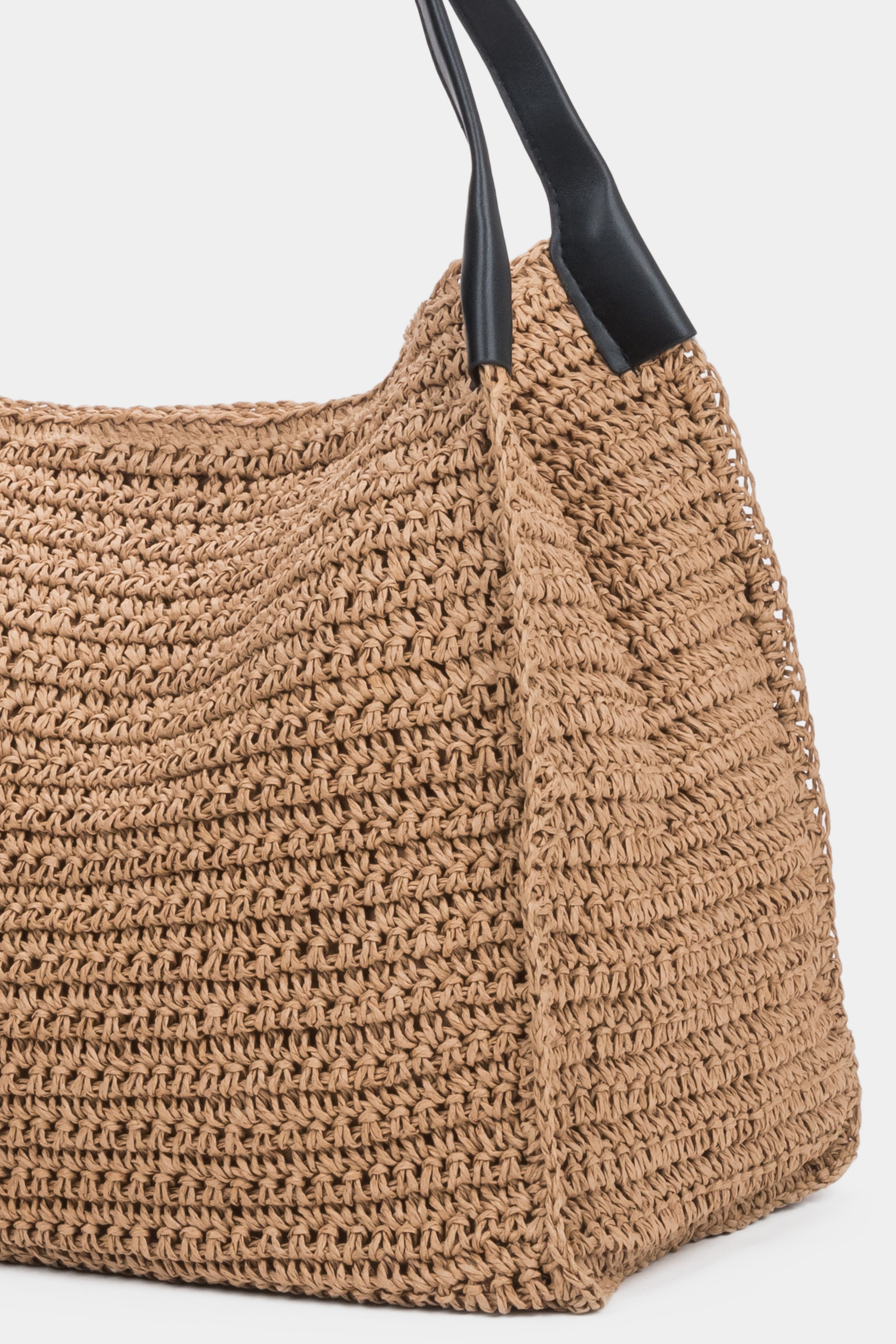 Detail view of woven straw texture on beige Estro shopper bag