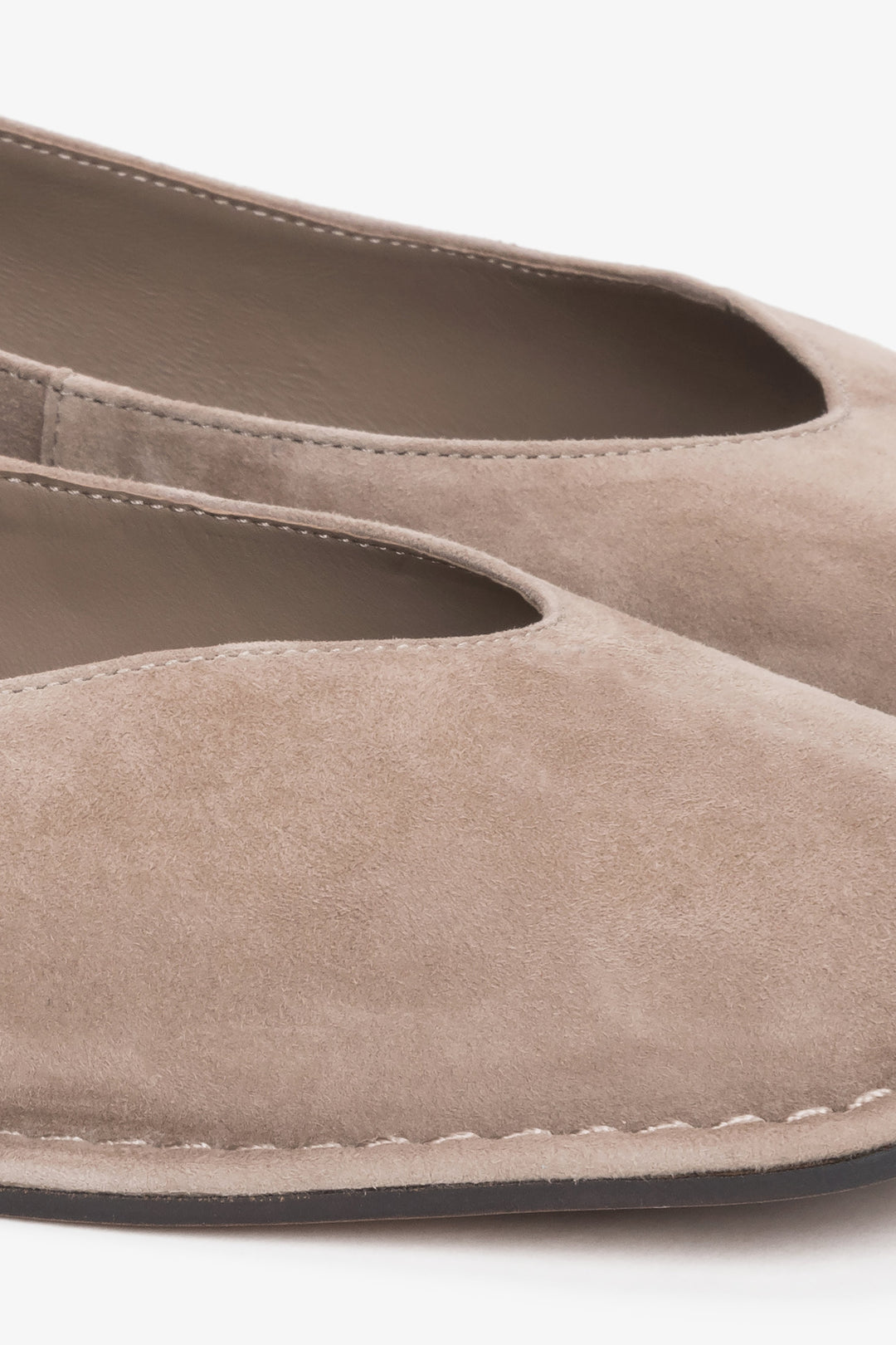 Detail view of decorative stitching on beige velour ballet flats by Estro