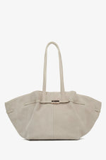 Women's beige velour handbag by Estro, featuring long handles.