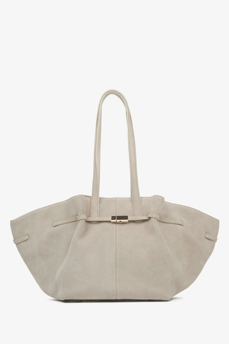 Women's beige velour handbag by Estro, featuring long handles.