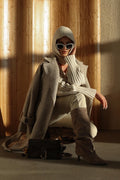 Made of genuine velour, women's beige knee-high boots with a low flared heel Estro.