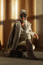 Made of genuine velour, women's beige knee-high boots with a low flared heel Estro.