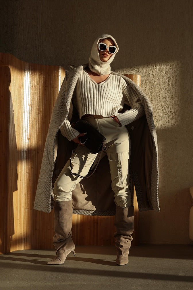 Women's beige knee-high boots made of genuine velour with a low flared heel by Estro.