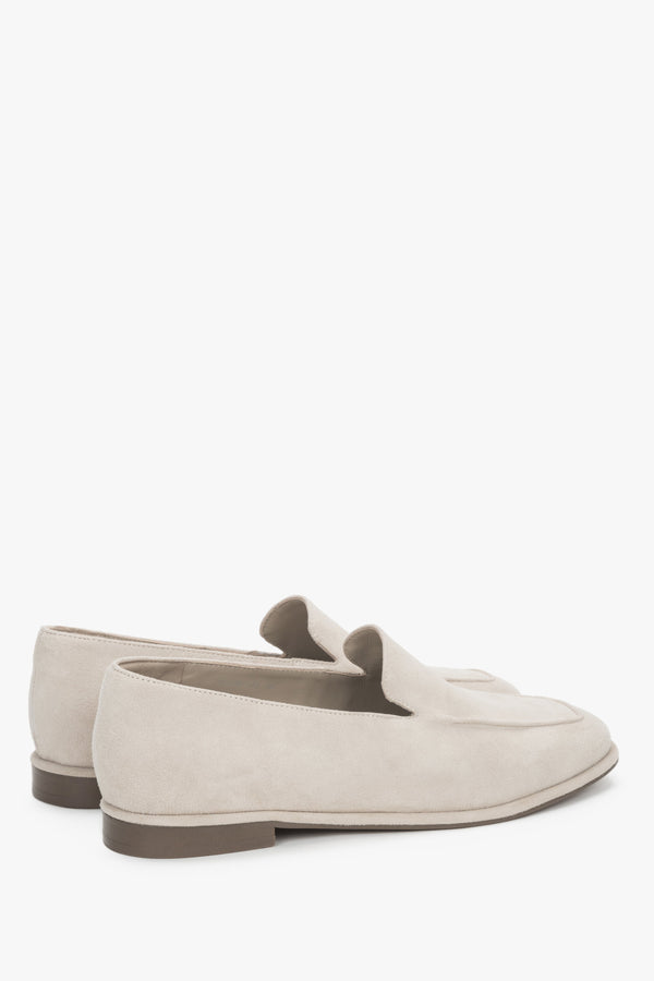 Angled view of women's beige velour loafers with decorative stitching