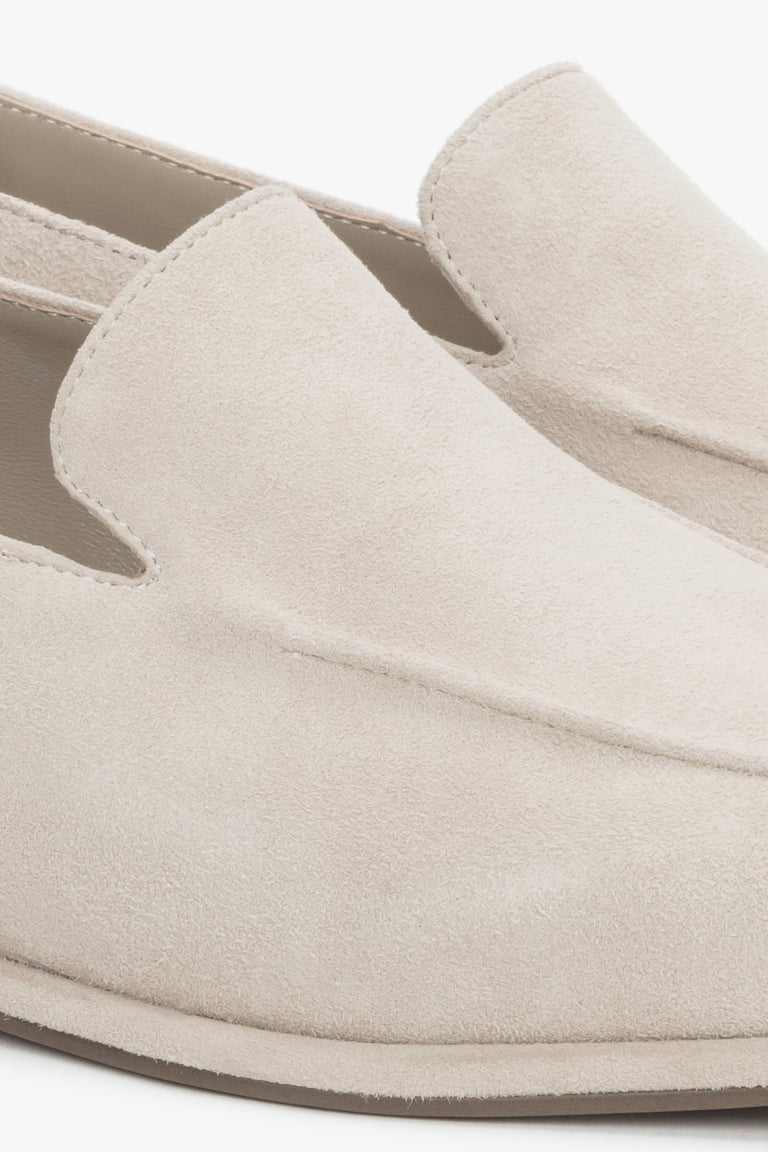 Detail view of decorative stitching on beige velour loafers by Estro