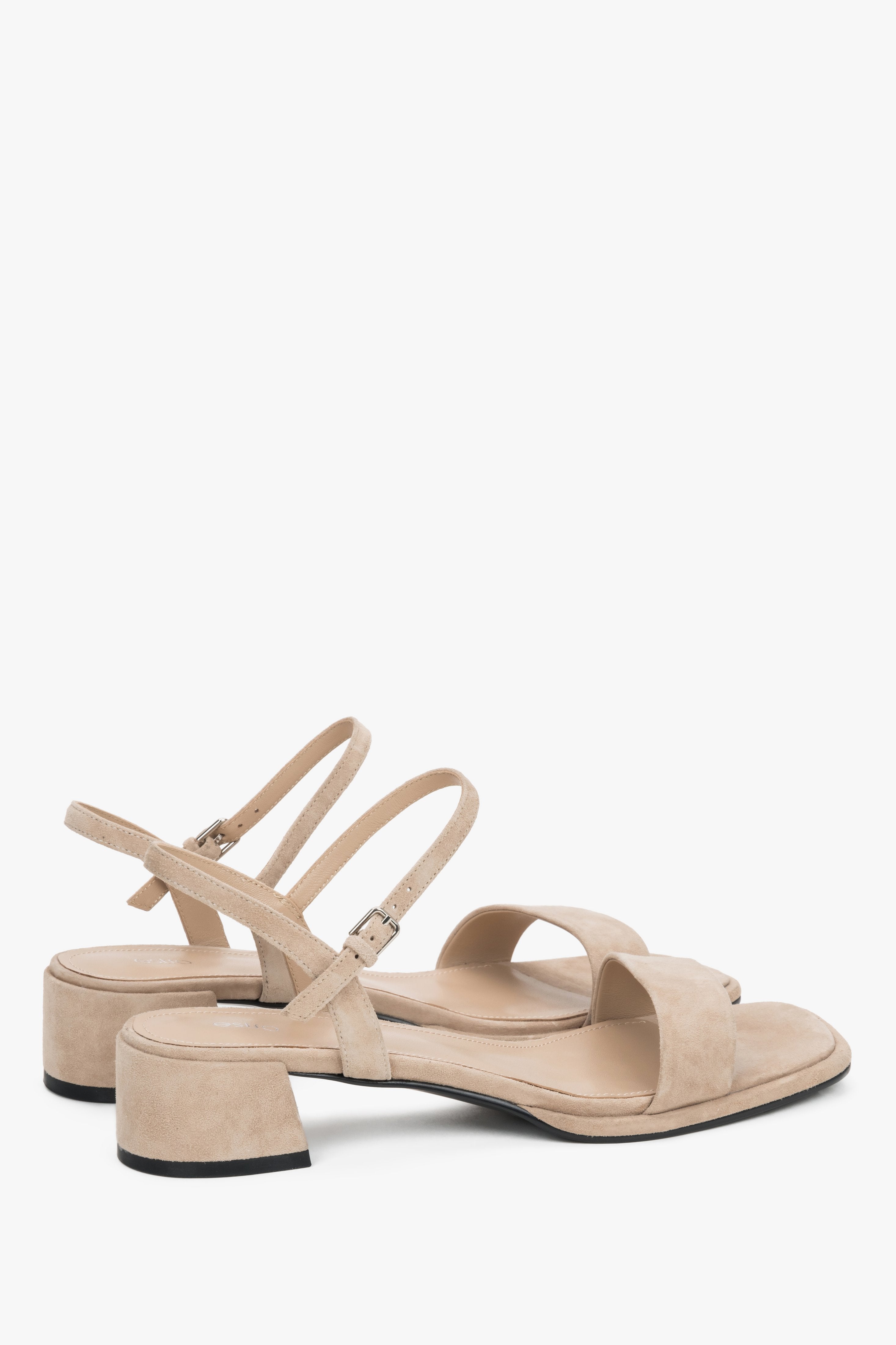 Close-up of the warm sand-colored velour texture and square block heel.