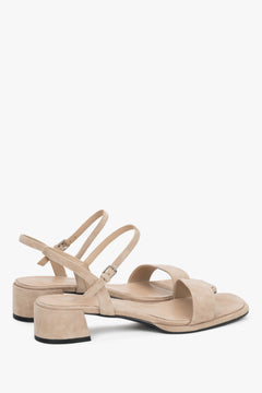 Close-up of the warm sand-colored velour texture and square block heel.